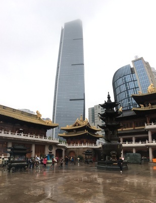 Jing'an temple grounds with a skyscraper in the background